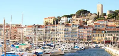 a bunch of boats are docked in a harbor at CANNES plage 2mn/45m2/vue mer/inernet/clim/parking privé in Cannes