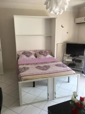 a bed sitting in a room with a tv at Studio Cannes la Croisette in Cannes