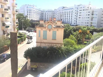 a building with a clock on it on a city street at Studio Cannes la Croisette in Cannes