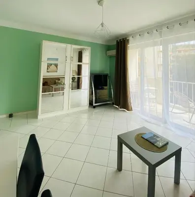 a living room with a table and a tv at Studio Cannes la Croisette in Cannes