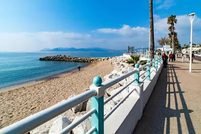 a fence on a beach next to the ocean at Mini Duplex 50m du Vieux Port in Cannes