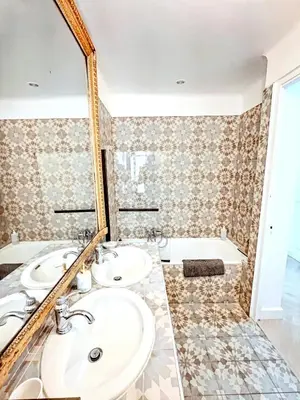 a bathroom with two sinks and a mirror at Mini Duplex 50m du Vieux Port in Cannes