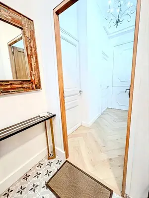 a hallway with a mirror and a table at Mini Duplex 50m du Vieux Port in Cannes