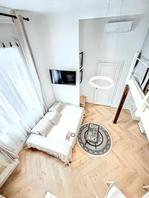a white room with a bed and a window at Mini Duplex 50m du Vieux Port in Cannes