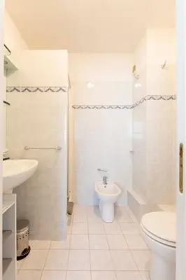a white bathroom with a toilet and a sink at Apartment 2 bedrooms 2 bathrooms clear view in Palm beach area in Cannes
