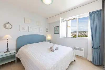 a bedroom with a bed with a teddy bear on it at Apartment 2 bedrooms 2 bathrooms clear view in Palm beach area in Cannes
