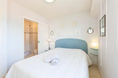 a white bedroom with a bed with a towel on it at Apartment 2 bedrooms 2 bathrooms clear view in Palm beach area in Cannes
