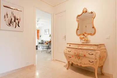 a mirror on top of a dresser in a room at Palais Royal YourHostHelper in Cannes