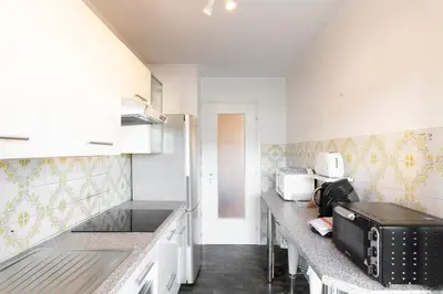 a kitchen with white cabinets and a counter top at Palais Royal YourHostHelper in Cannes