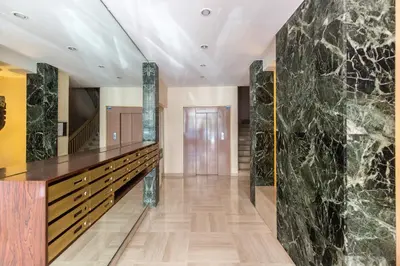 a lobby with a large marble wall at Palais Royal YourHostHelper in Cannes