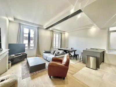 a living room with a couch and a table at Jaurès Home by Welcome to Cannes in Cannes