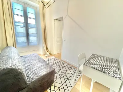 a room with a couch and a table and a window at Jaurès Home by Welcome to Cannes in Cannes