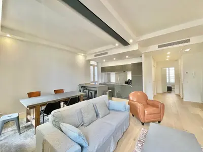 a living room with a couch and a table at Jaurès Home by Welcome to Cannes in Cannes