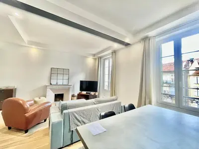 a living room with two couches and a fireplace at Jaurès Home by Welcome to Cannes in Cannes