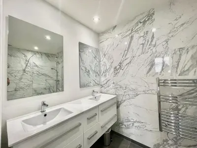 a bathroom with two sinks and a marble wall at Jaurès Home by Welcome to Cannes in Cannes