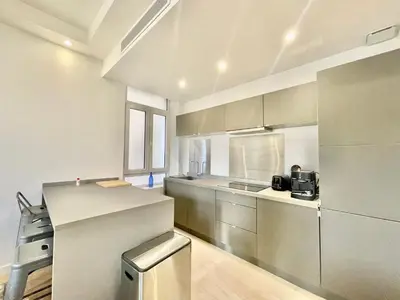 a kitchen with stainless steel appliances in a room at Jaurès Home by Welcome to Cannes in Cannes