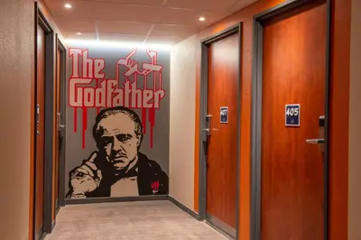a hallway with a poster of the godfather on the wall at ibis budget Cannes Centre Ville in Cannes