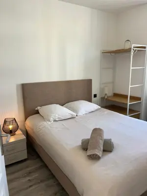a bedroom with a large bed with two towels on it at keep in touch 2 CHAMBRES AVEC TERRASSE ET GARAGE in Cannes