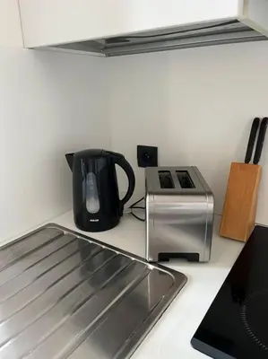 a kitchen counter with a coffee pot and a toaster at keep in touch 2 CHAMBRES AVEC TERRASSE ET GARAGE in Cannes