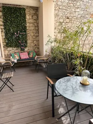 a patio with a bench and tables and chairs at keep in touch 2 CHAMBRES AVEC TERRASSE ET GARAGE in Cannes