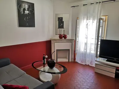 a living room with a couch and a glass table at 5 min to sea and Palais des Festivals in Cannes