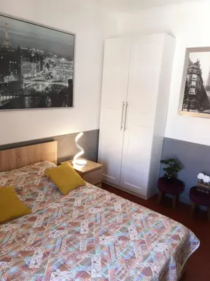 a bedroom with a bed and a white cabinet at 5 min to sea and Palais des Festivals in Cannes