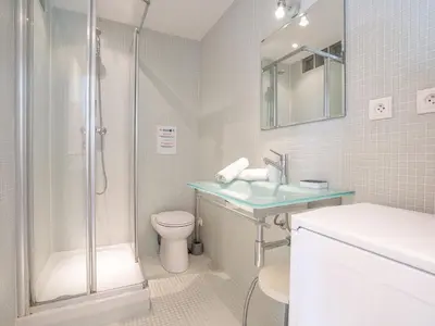 a bathroom with a shower and a sink and a toilet at Apartment Le Cheverny by Interhome in Cannes