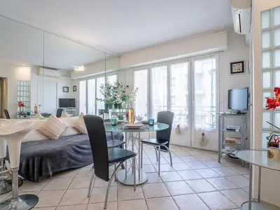 a living room with a bed and a table at Apartment Le Cheverny by Interhome in Cannes