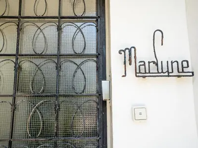 a door with a iron gate with a sign that reads romance at Apartment Le Marlyne 1 by Interhome in Cannes