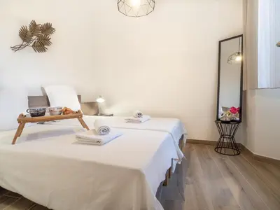 a room with two beds and a mirror at Loft de standing Cannes in Cannes