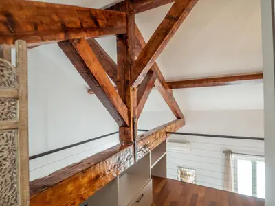 a room with wooden beams and white walls at Loft de standing Cannes in Cannes