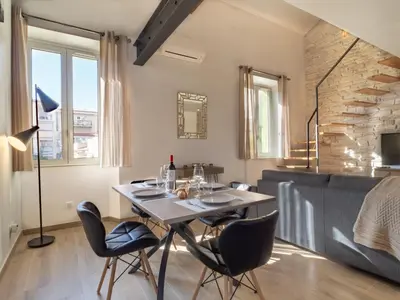 a dining room with a table and two chairs at Loft de standing Cannes in Cannes