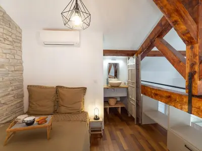 a living room with a bed and a table at Loft de standing Cannes in Cannes