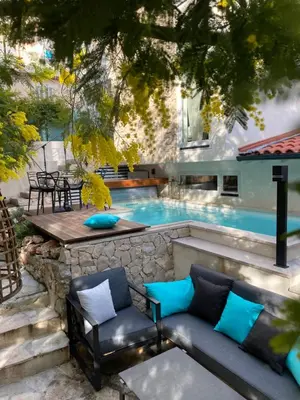 a swimming pool with a couch and chairs next to it at Cannes cote sud in Cannes