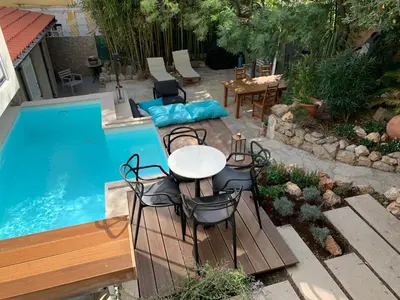 a table and chairs next to a swimming pool at Cannes cote sud in Cannes