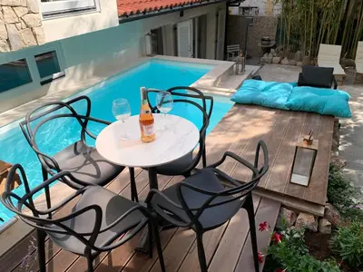 a table and chairs next to a swimming pool at Cannes cote sud in Cannes