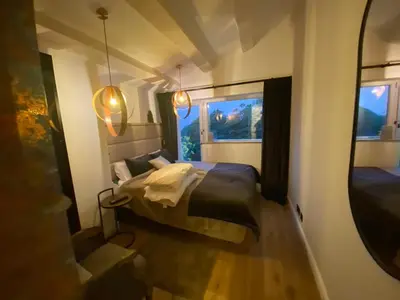 a small bedroom with a bed and a mirror at Cannes cote sud in Cannes