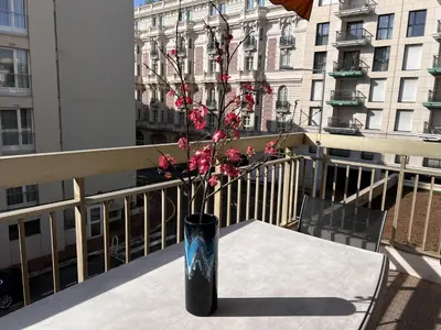a vase with pink flowers sitting on a table on a balcony at One bedroom apartment in the center of Cannes, next to the Carlton, a few meters from the Croisette - 367 in Cannes