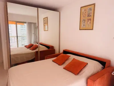 a bedroom with two beds and a mirror at One bedroom apartment in the center of Cannes, next to the Carlton, a few meters from the Croisette - 367 in Cannes