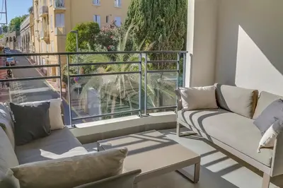 a balcony with couches and a view of a street at IMMOGROOM- Modern - Elegant - Close to the beach -AC in Cannes