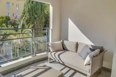a living room with a couch and a large window at IMMOGROOM- Modern - Elegant - Close to the beach -AC in Cannes
