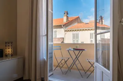 a view of a balcony with a table and chairs at Spacious one bedroom - great location! in Cannes