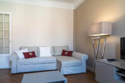 a living room with a couch and a lamp at Spacious one bedroom - great location! in Cannes