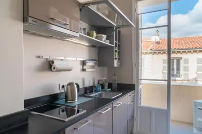 a kitchen with a sink and a window at Spacious one bedroom - great location! in Cannes