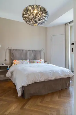 a bedroom with a large bed and a chandelier at Spacious one bedroom - great location! in Cannes