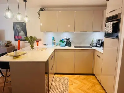 a kitchen with white cabinets and a counter top at Lovely one bedroom apartment with balcony & wifi just minutes walk from Palais and Cannes beaches 109 in Cannes