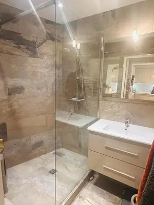 a bathroom with a glass shower and a sink at Lovely one bedroom apartment with balcony & wifi just minutes walk from Palais and Cannes beaches 109 in Cannes