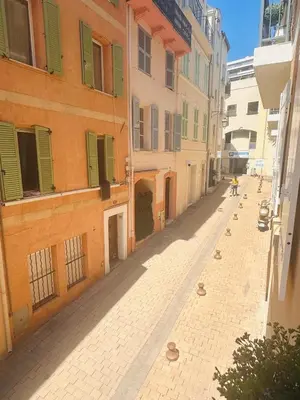 an empty street in an alley between buildings at Lovely one bedroom apartment with balcony & wifi just minutes walk from Palais and Cannes beaches 109 in Cannes