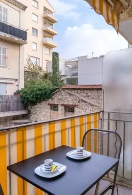 two cups of coffee sitting on a table on a balcony at 3 pièces- Vieux port- Terrasse - Parking Possible in Cannes