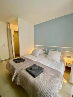 a bedroom with a bed with two towels on it at 3 pièces- Vieux port- Terrasse - Parking Possible in Cannes